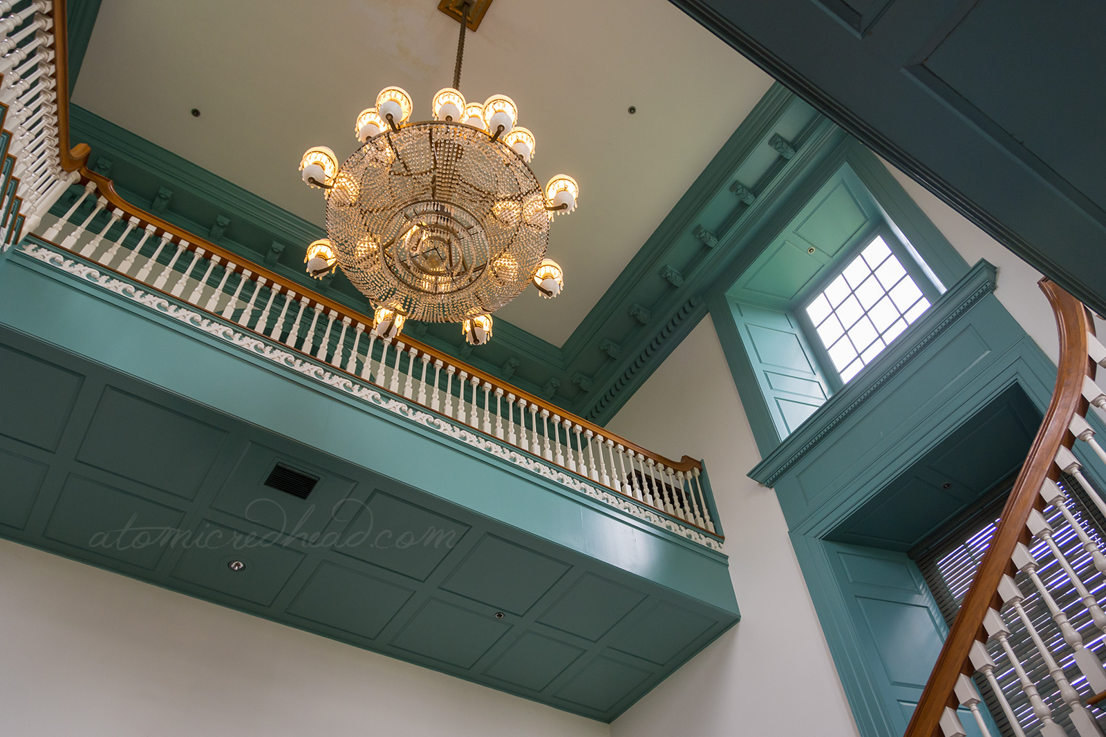 Inside Independence Hall, a large chandelier hangs from the ceiling.