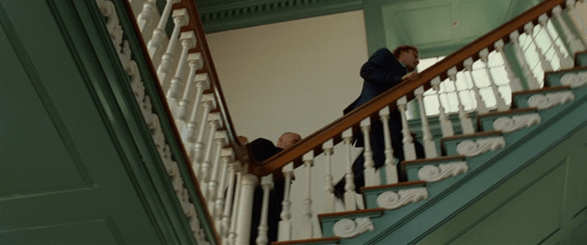 National Treasure Screencap: A group of men walk up a staircase inside Independence Hall.