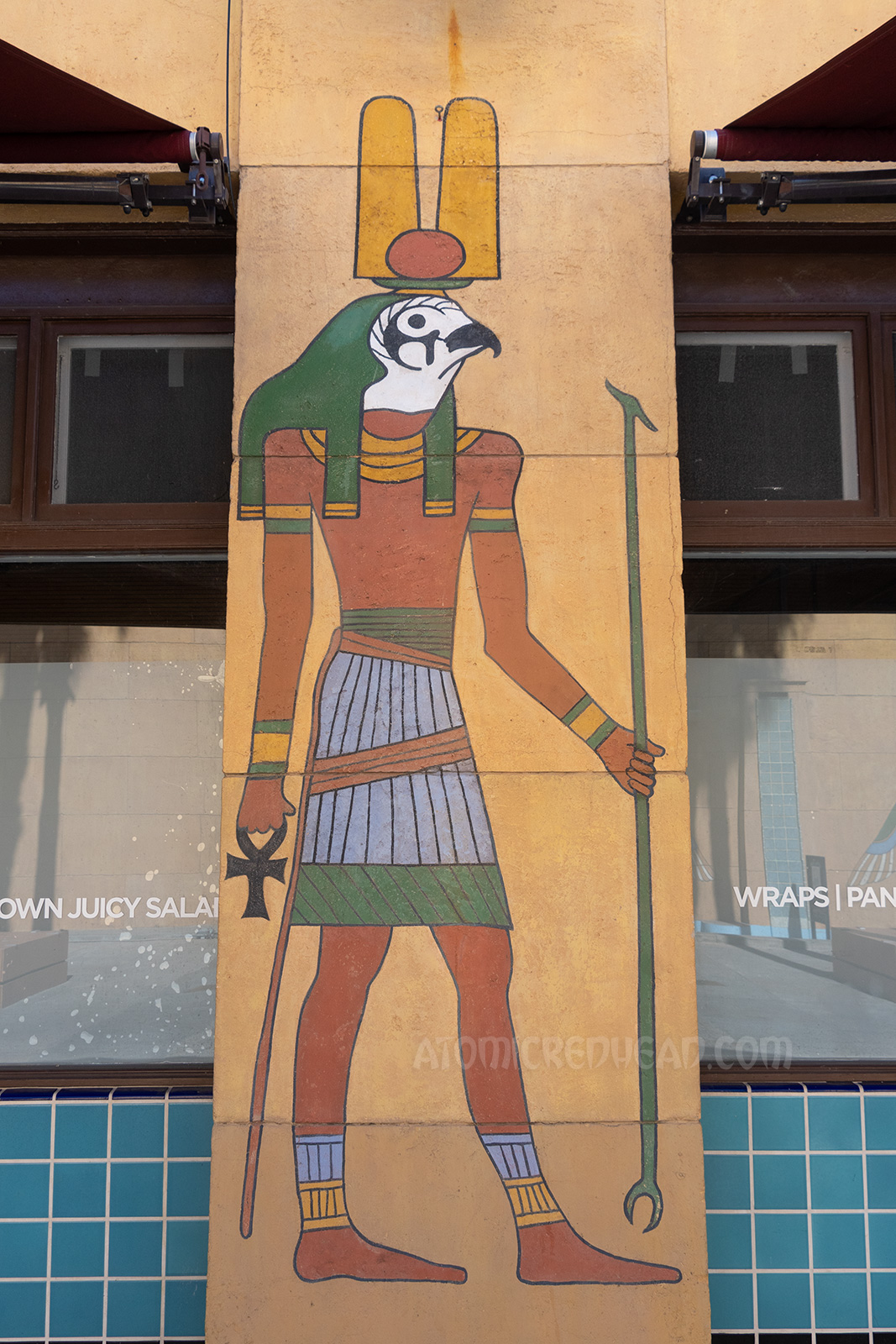 A painted mural of the Egyptian god Horus, which is a man's body with the head of a hawk.