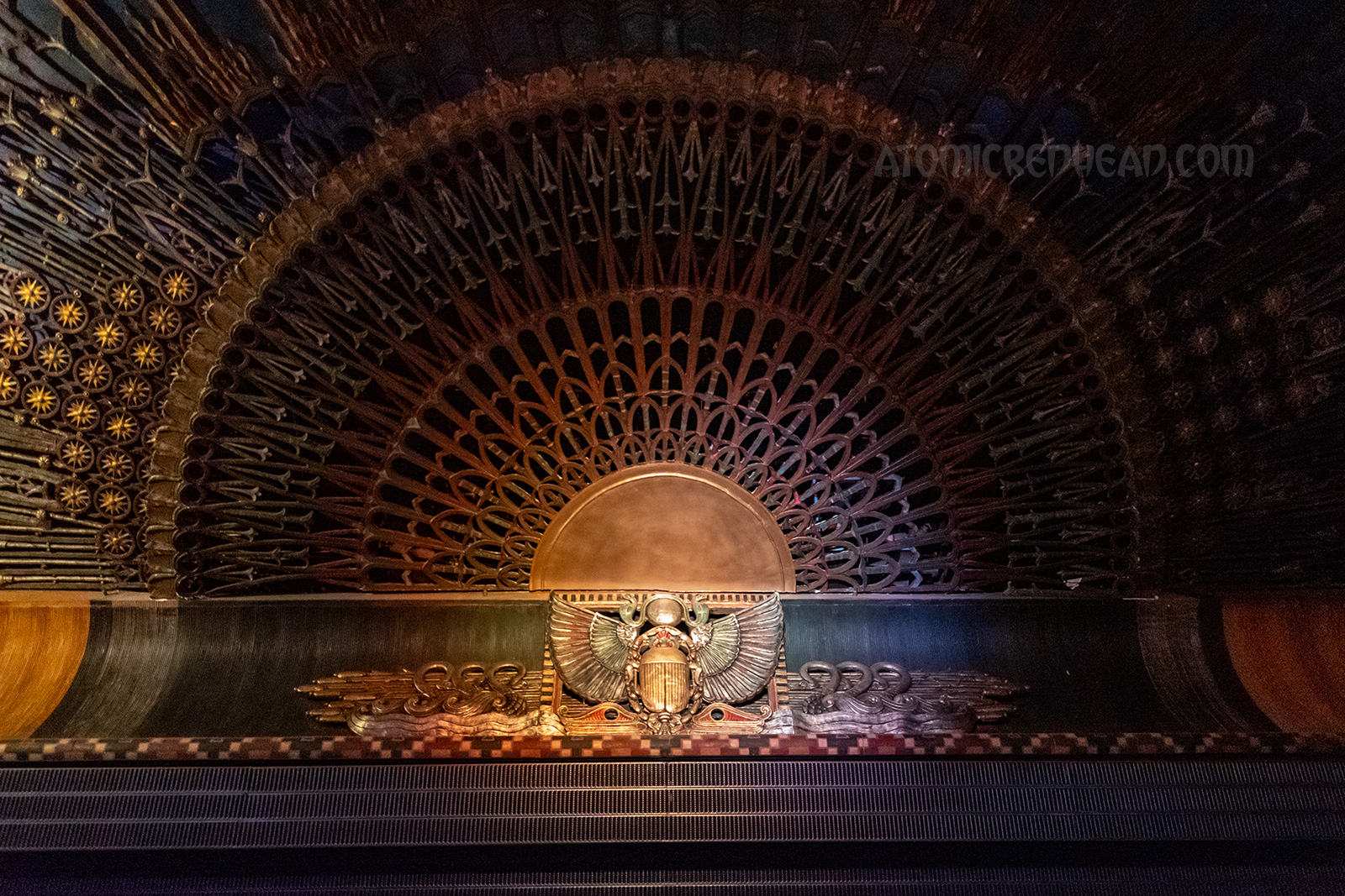 Above the seating in the theatre is a massive winged scarab with a sunburst design radiating outwards.