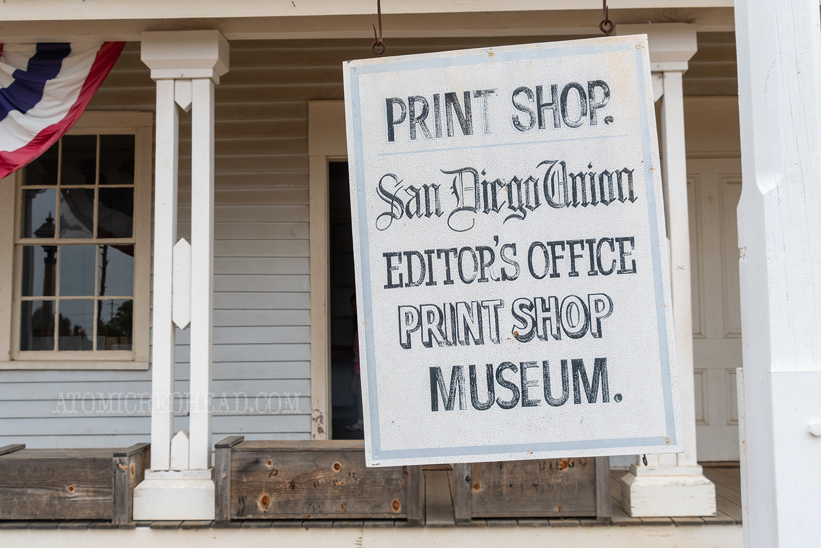 A hanging white sign reads "Print Shop. San Diego Union Editor's Office Print Shop Museum"