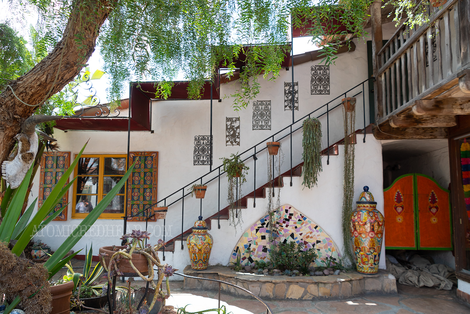 An adobe staircase with red tile steps.