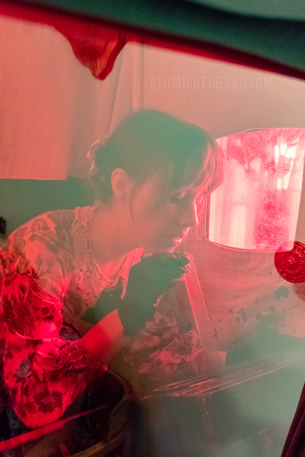 Catherine inserts the metal plate into a solution of silver nitrate.