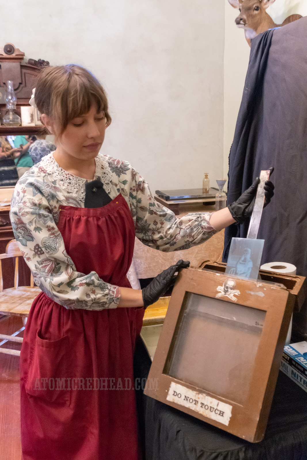 Catherine places the plate into diluted potassium cyanide to expose the negative.