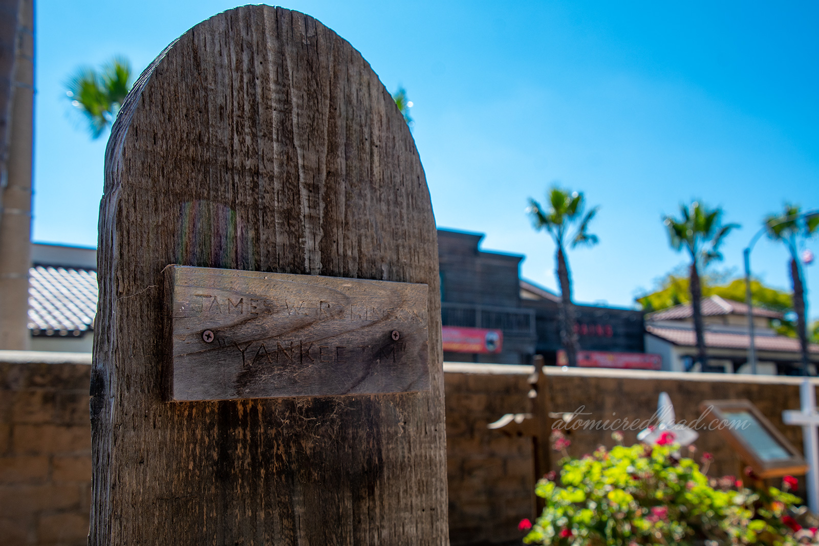 A wooden tombstone reading "James Robinson 'Yankee Jim'"