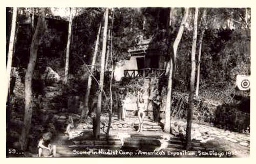 A nude woman lounges on a stone bench, trees surround her.