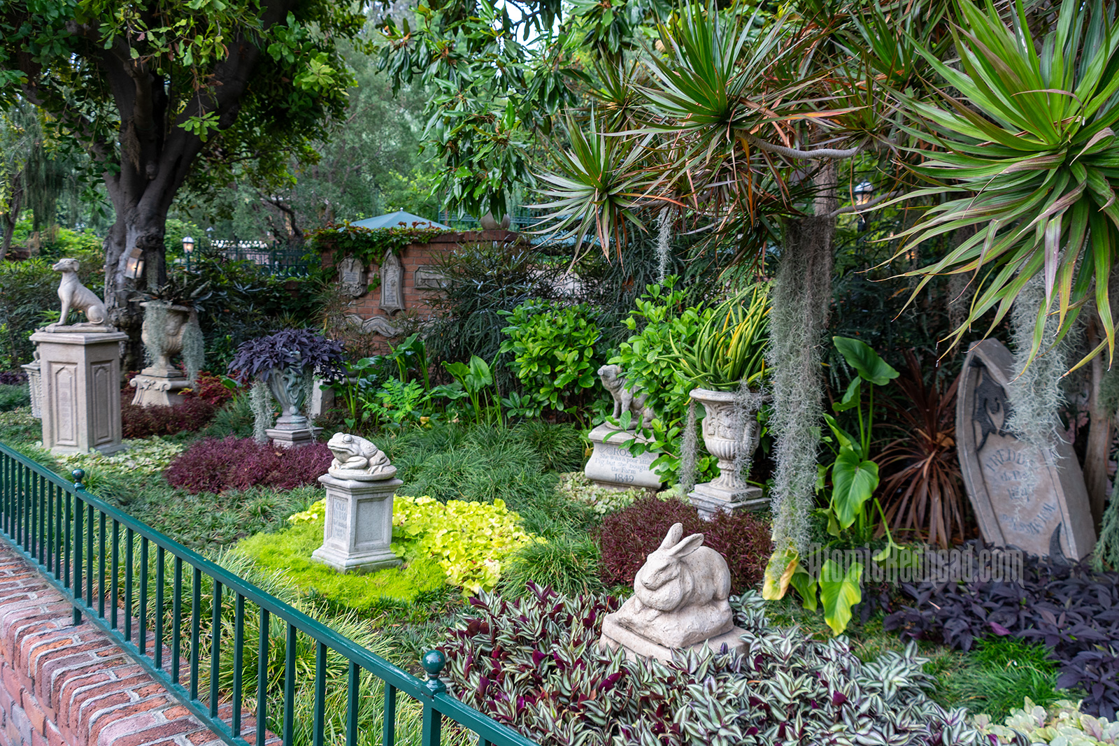 A pet cemetery out front featuring statues of various animals including a rabbit, front, pig and more.