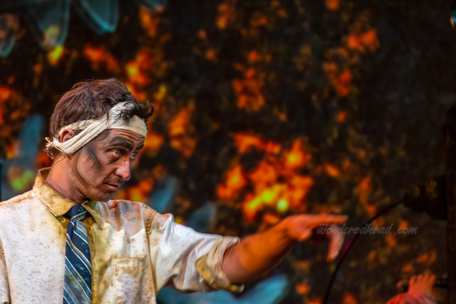 Dr. Scratch, who was injured in a fire, and head is bandaged, points to his next victim,