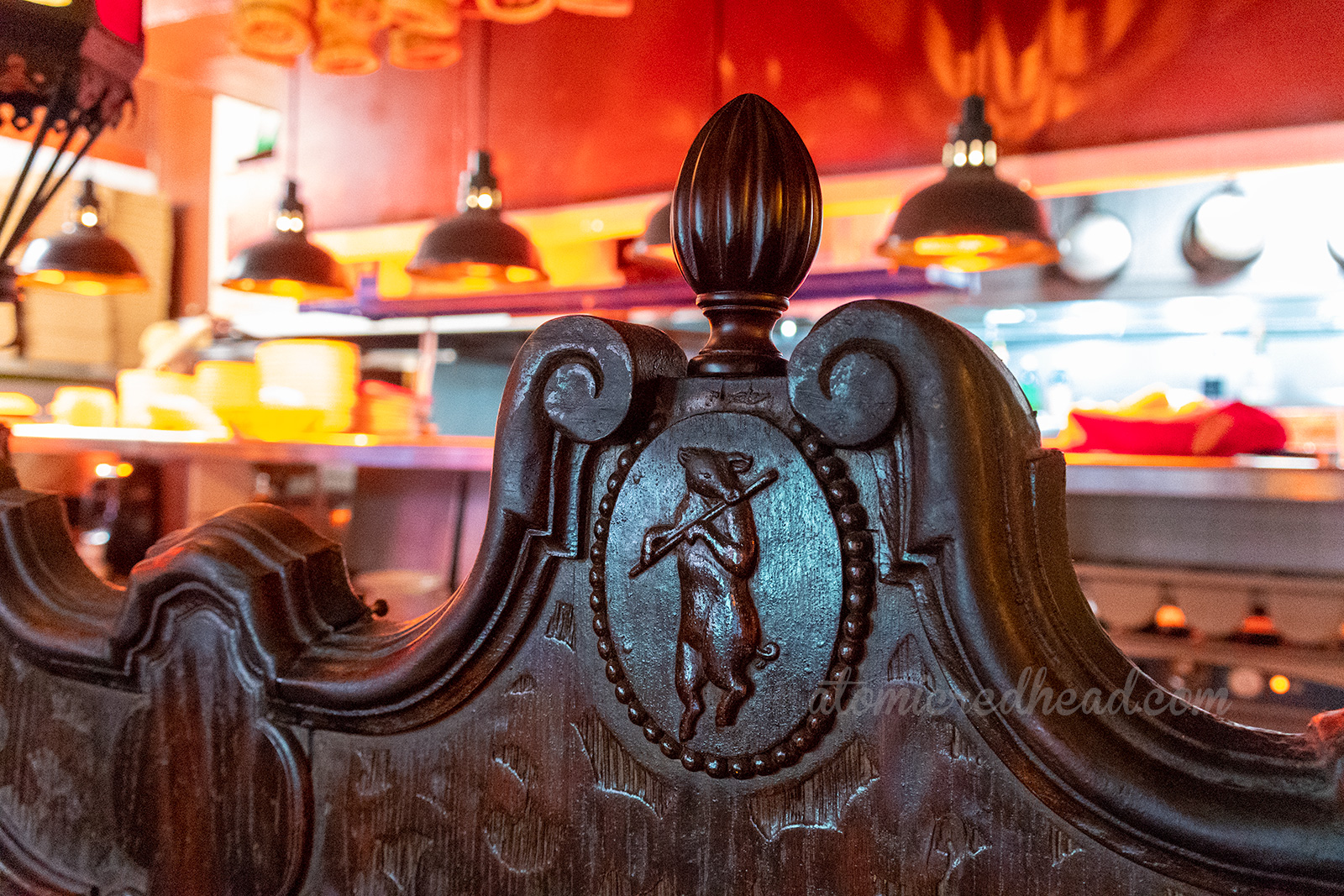 A close-up of a the carved wooden pig with flute.
