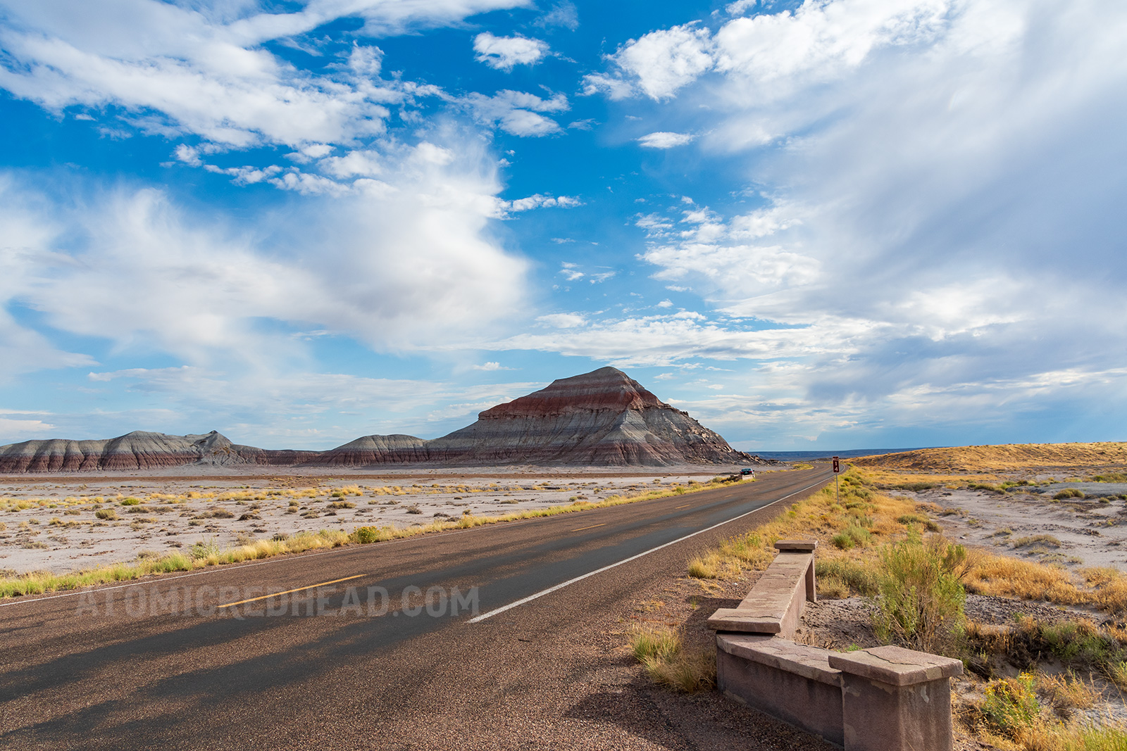 A colorful mountain with lines of dark red, grey, and brown.