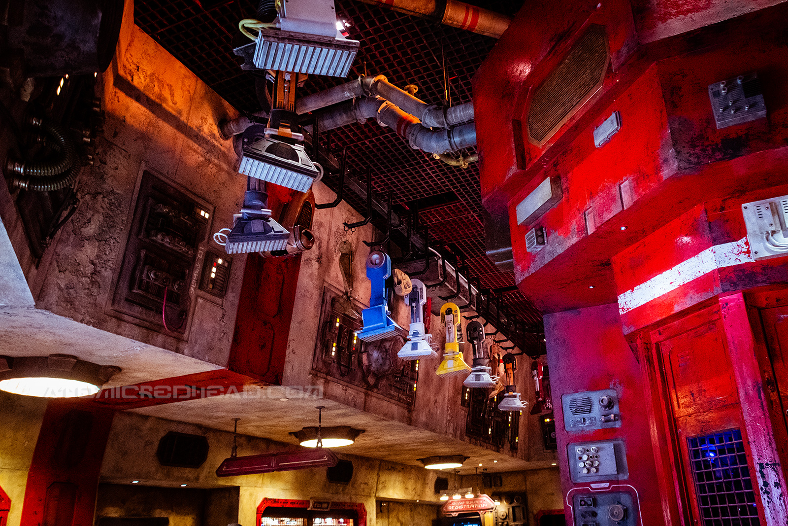 Various droid parts hang on a rack.