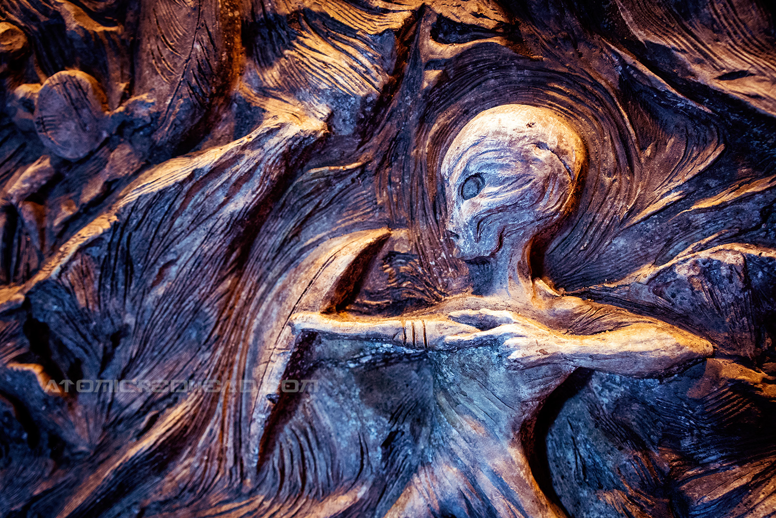 A carving of an alien like creature.