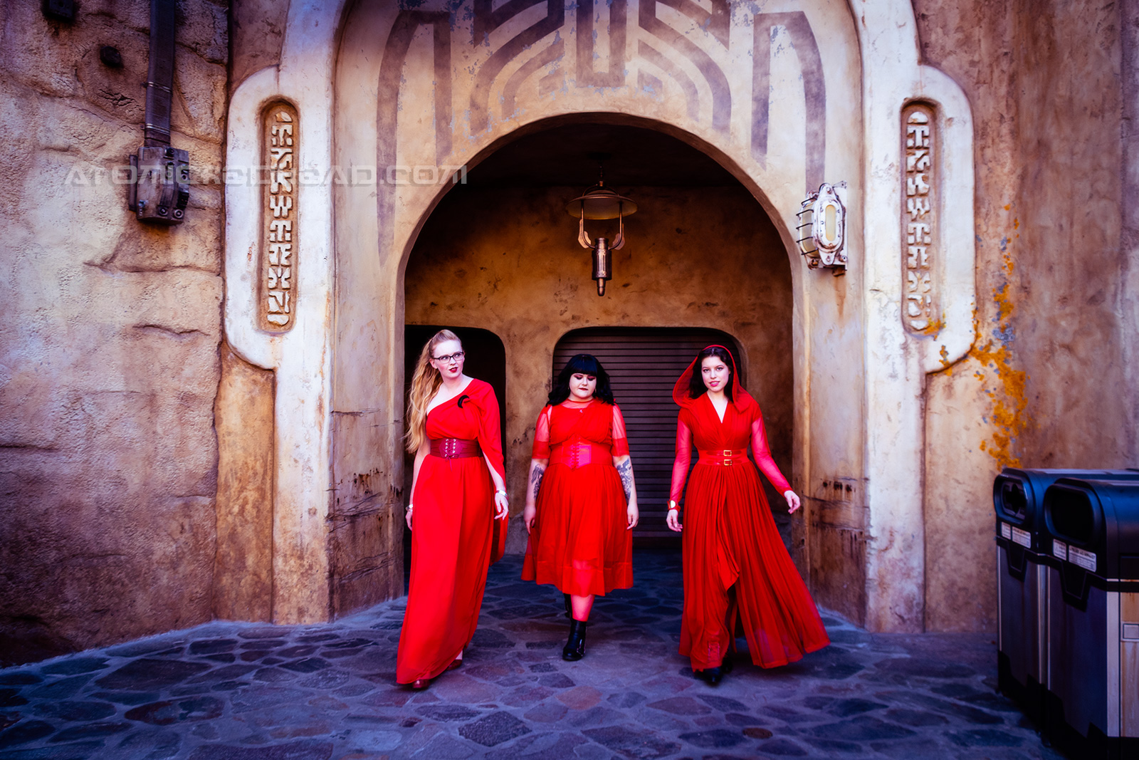 The trio of us wearing our red ensembles walking toward the camera.
