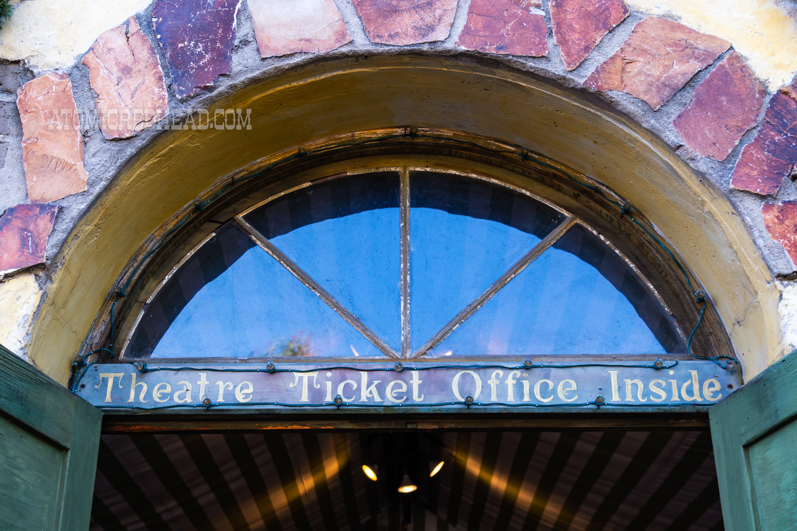 Close-up of script across the middle doorway reading "Theatre Ticket Office Inside"