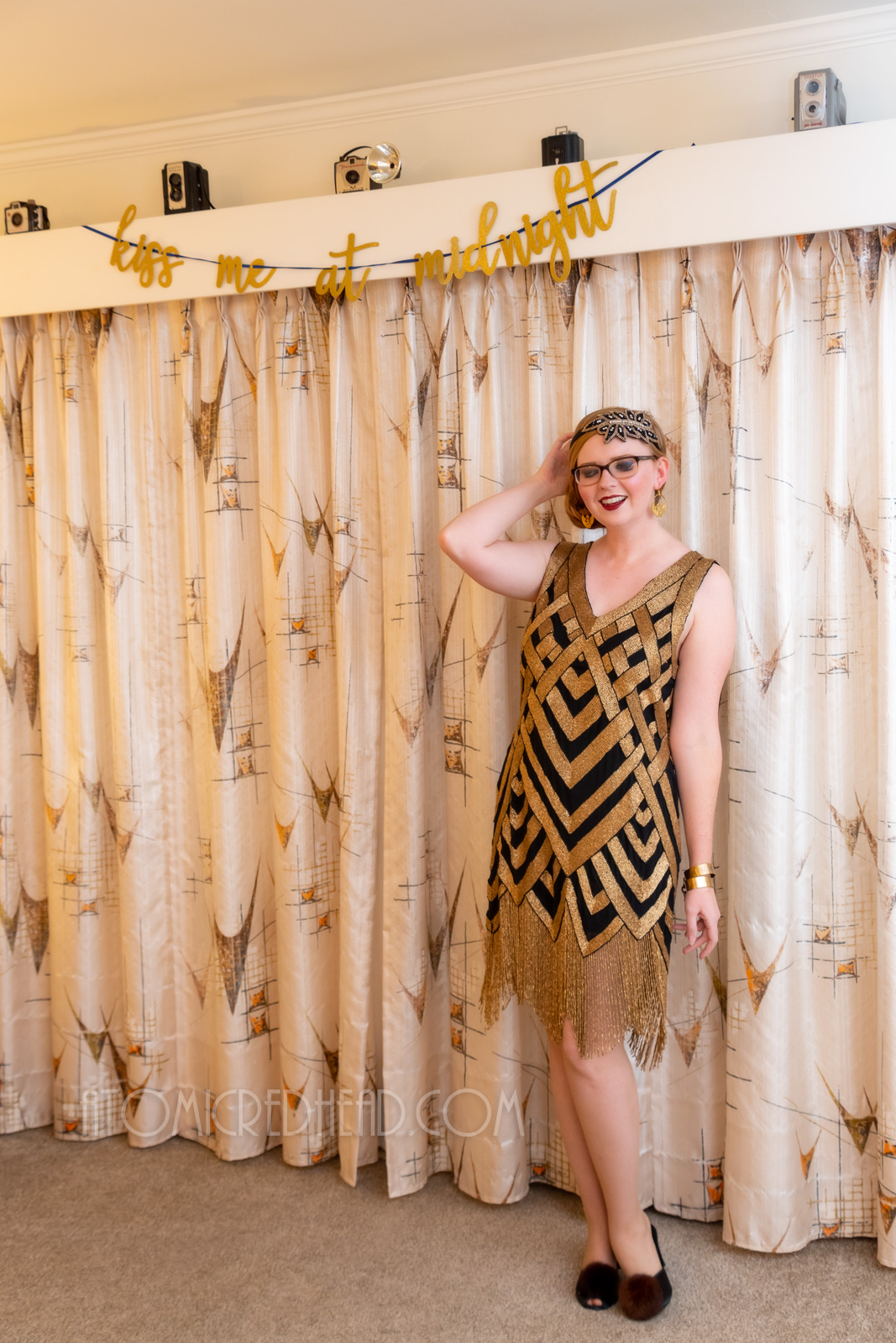 Myself, wearing a black and gold chevron patterned beaded flatter dress, with a black and gold headband.