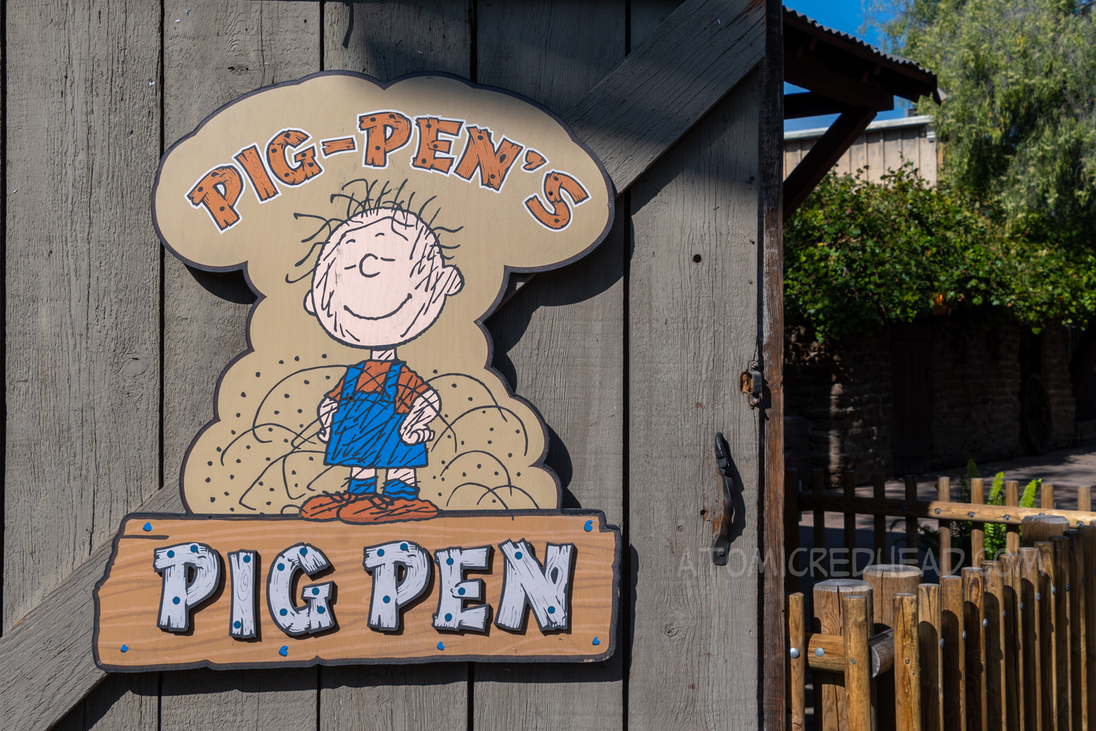 Sign for Pig-Pen's Pig Pen, which features the dirt covered character in his trademark overalls.