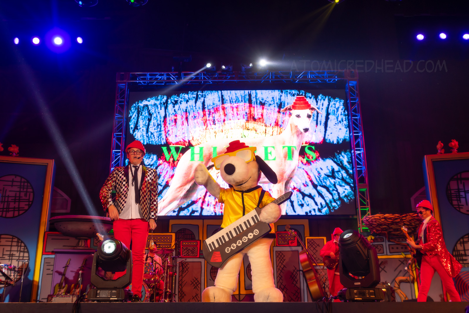 Snoopy in a parody of the bad Devo, with their iconic red hats, and keyboard. 