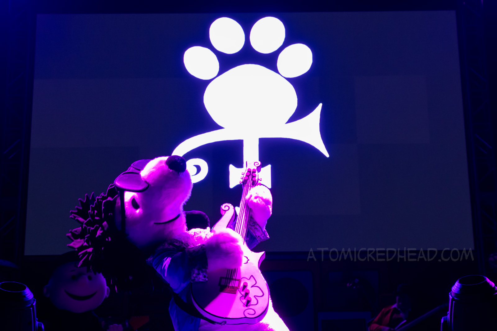 Snoopy parodying the artist Prince, as Paw-Prints, in the iconic Purple Rain outfit.