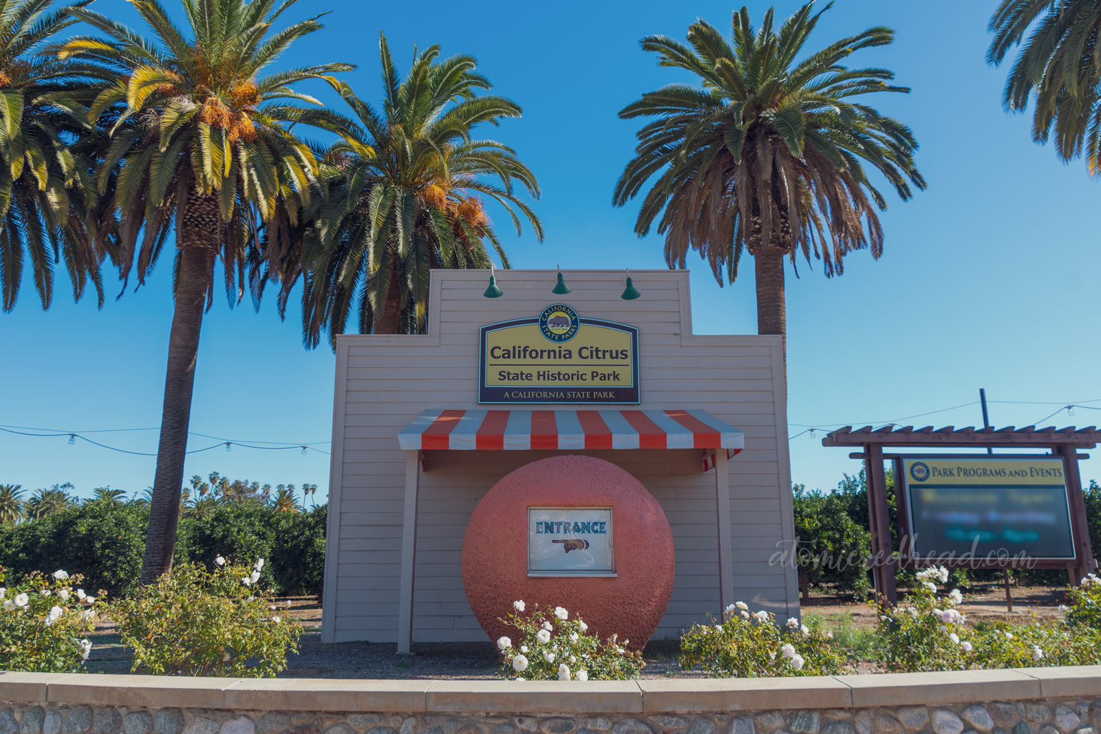 A small faux orange stand, which is shaped like an orange greets visitors as they turn down the street toward the park.