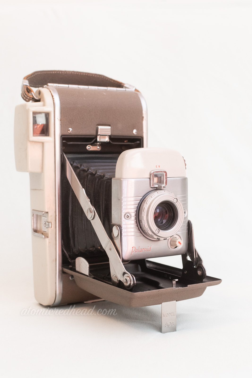 Polaroid Model 80B. A two tone silver camera with a bellows.
