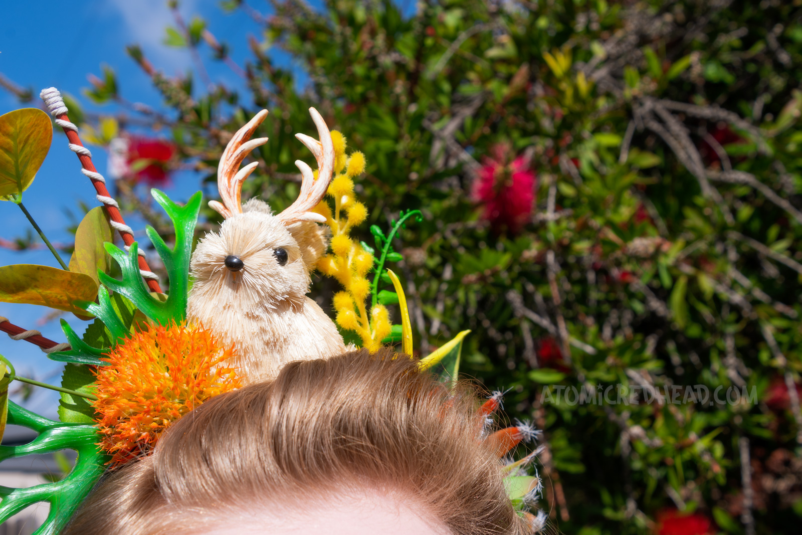 Close-up of my crown, which features green, orange, and yellow succulents, and a small cream colored jackalope.