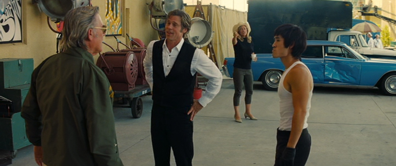 Randy stands with his back to the camera in front of Cliff and Lee, Janet stands in the backgrond.