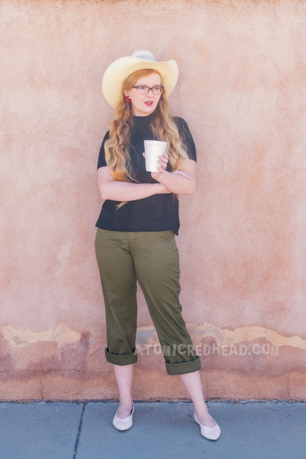 Myself wearing a straw cowboy hat, black mock turtle neck, olive capris and white pointed flats.