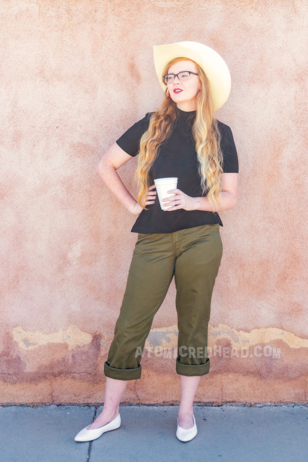 Myself wearing a straw cowboy hat, black mock turtle neck, olive capris and white pointed flats.