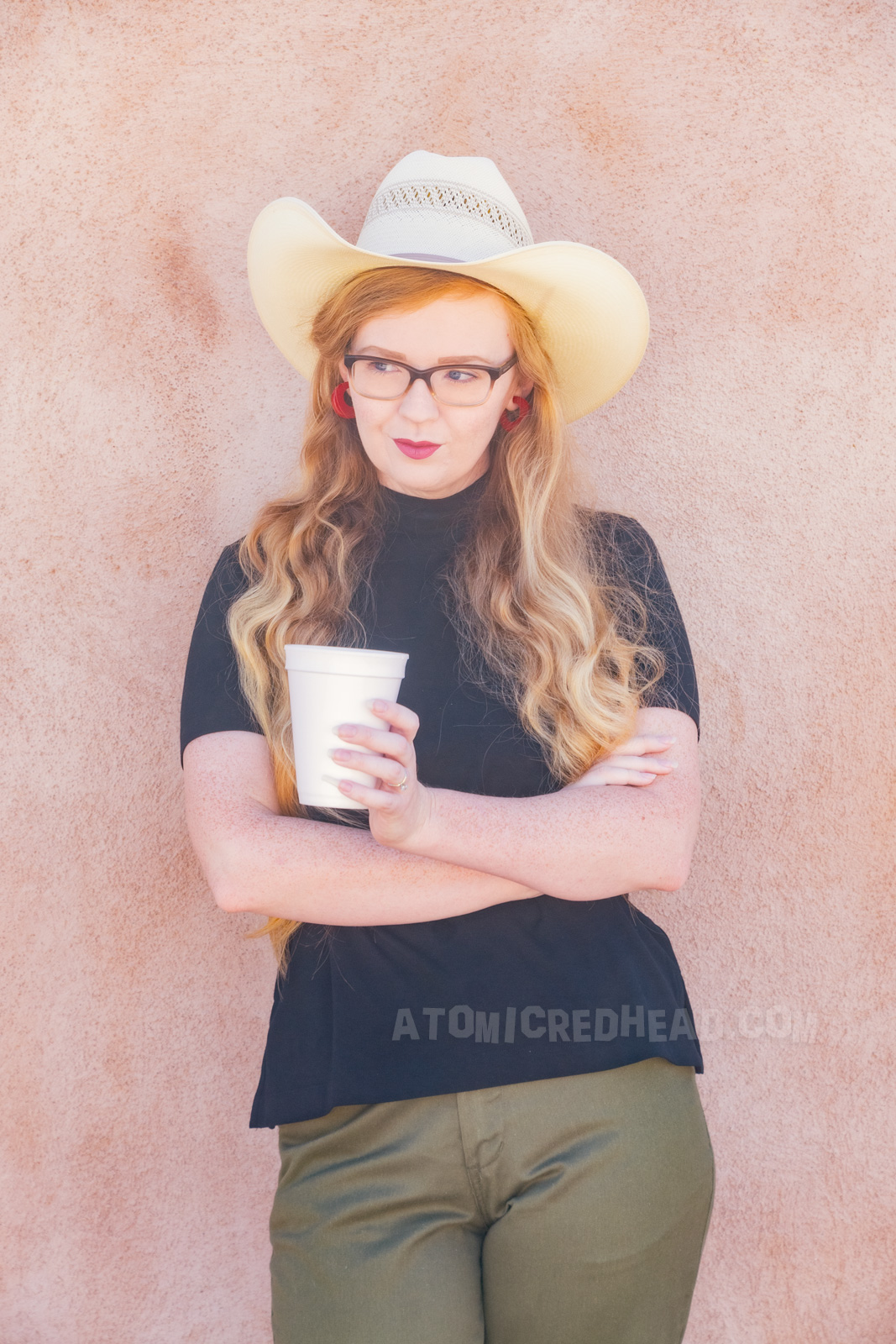 Myself wearing a straw cowboy hat, black mock turtle neck, olive capris and white pointed flats.