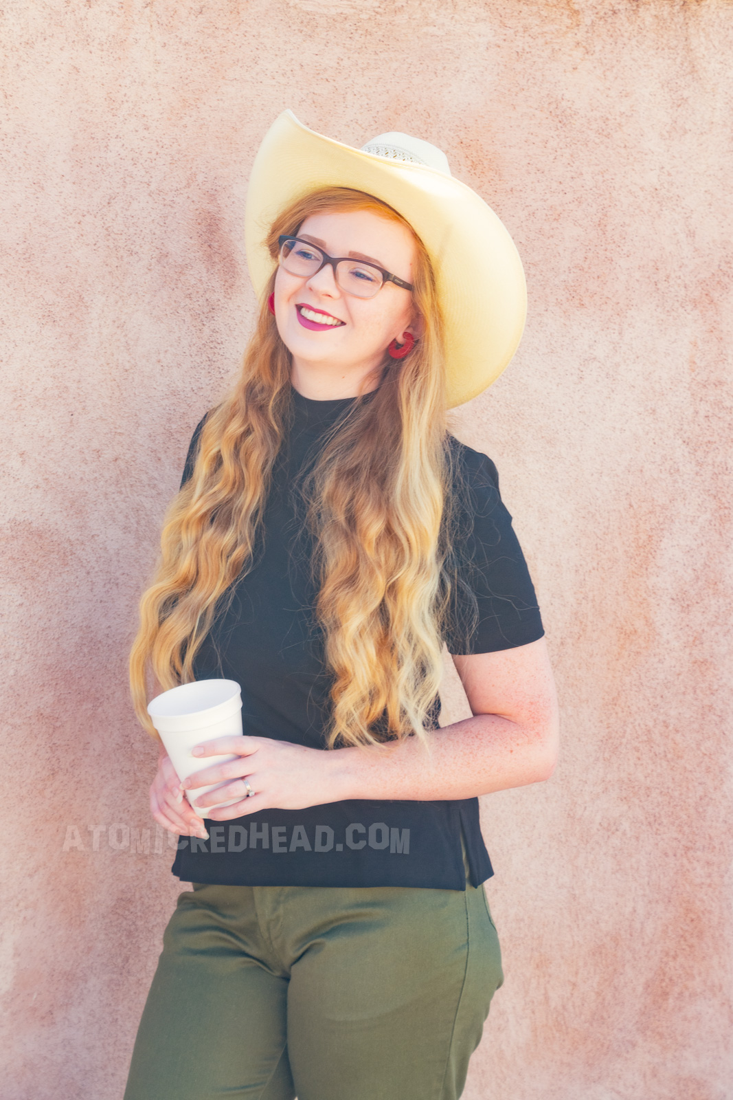 Myself wearing a straw cowboy hat, black mock turtle neck, olive capris and white pointed flats.