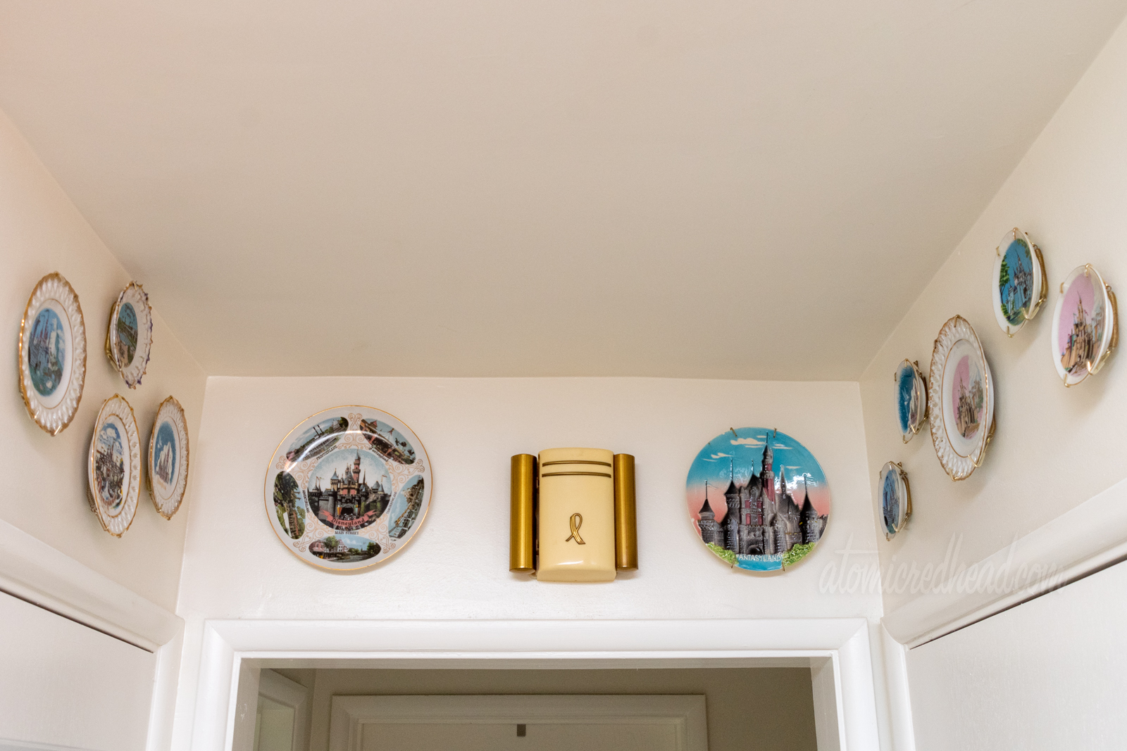 Various vintage Disneyland plates hang above three doorways.