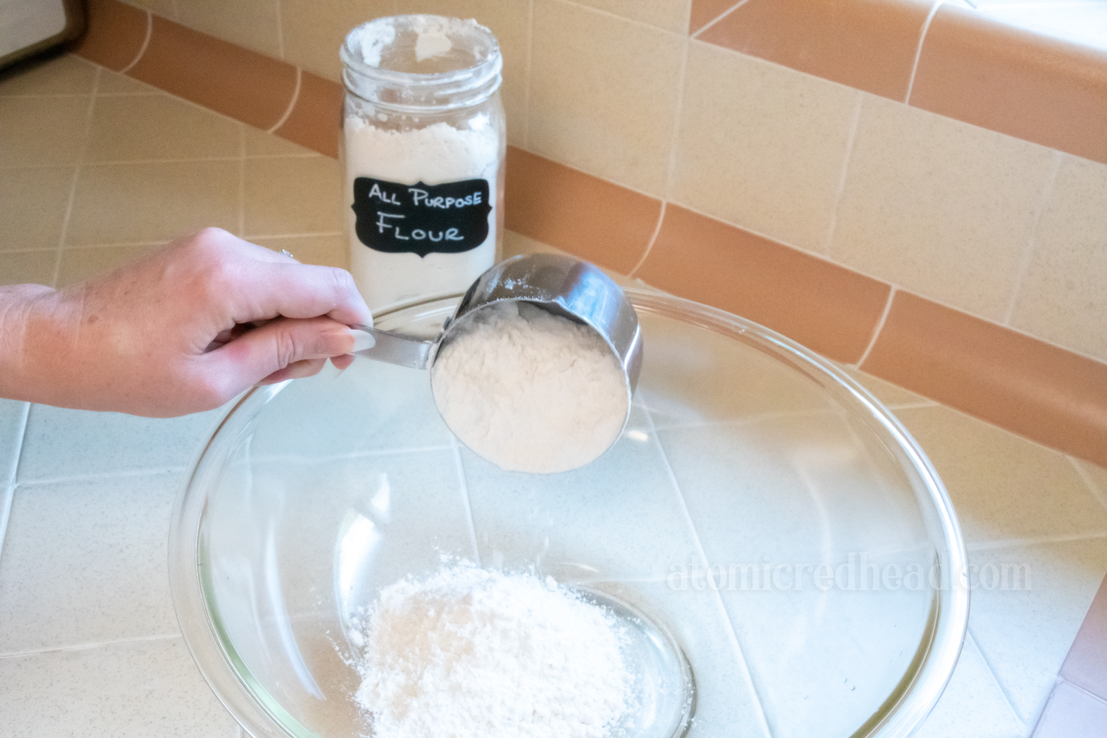 Pouring flour into a large bowl.