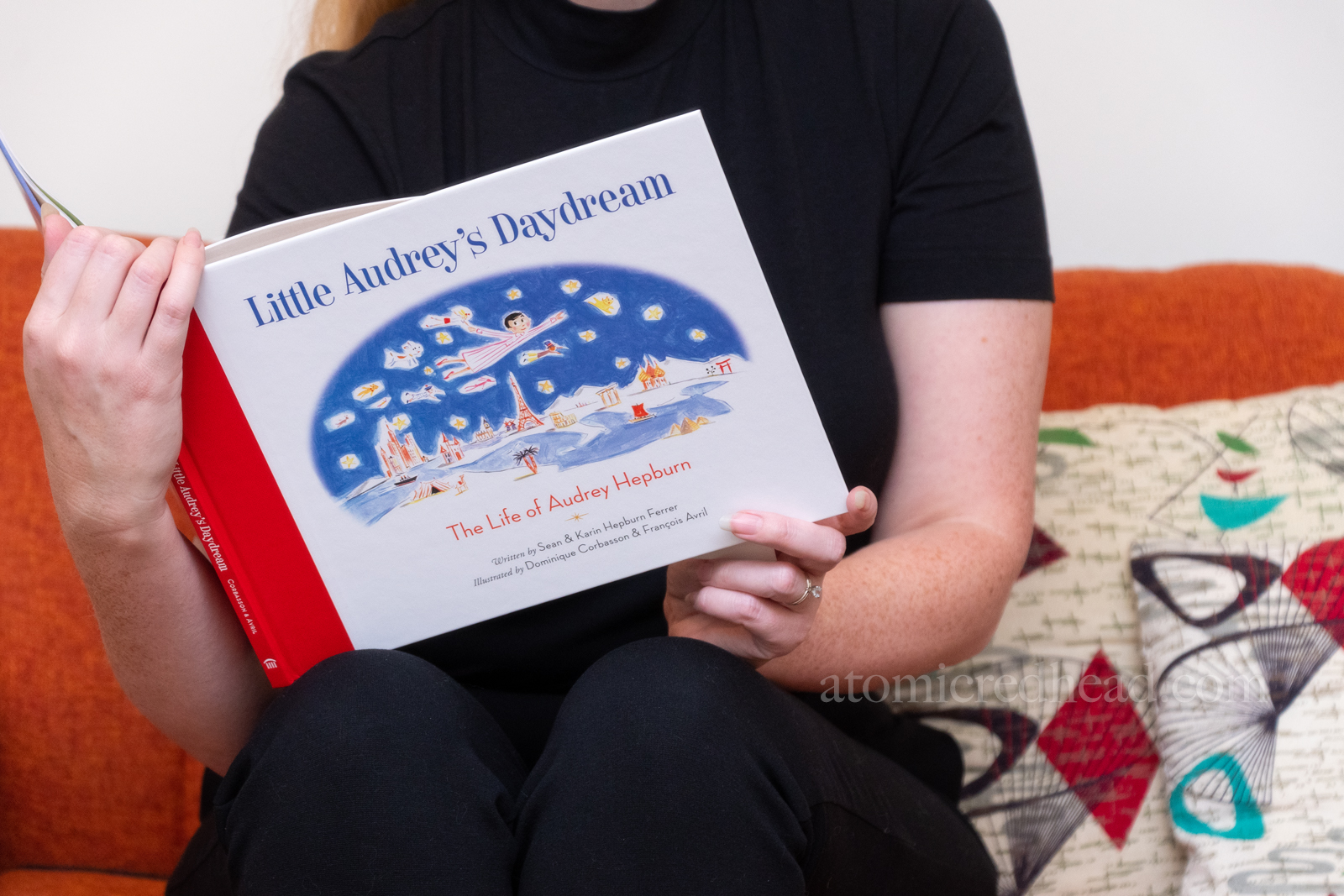 Close-up of the cover of the book, which features an illustration of a young Hepburn flying over various landmarks.