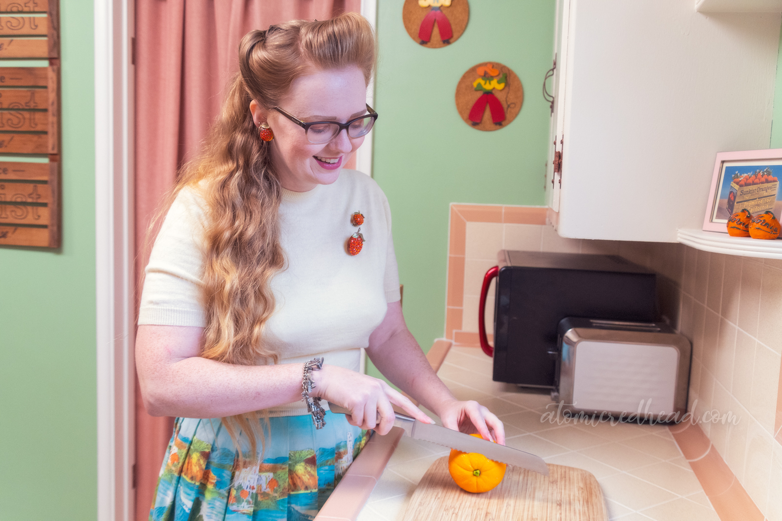 Myself in our kitchen cutting into the orange.