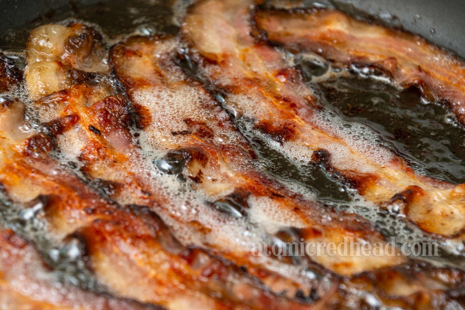 Bacon sizzling in the pan.