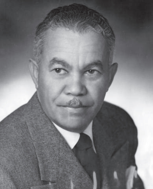Black and white photograph of Paul Revere Williams, a dapper gentleman in a suit with a small mustache.