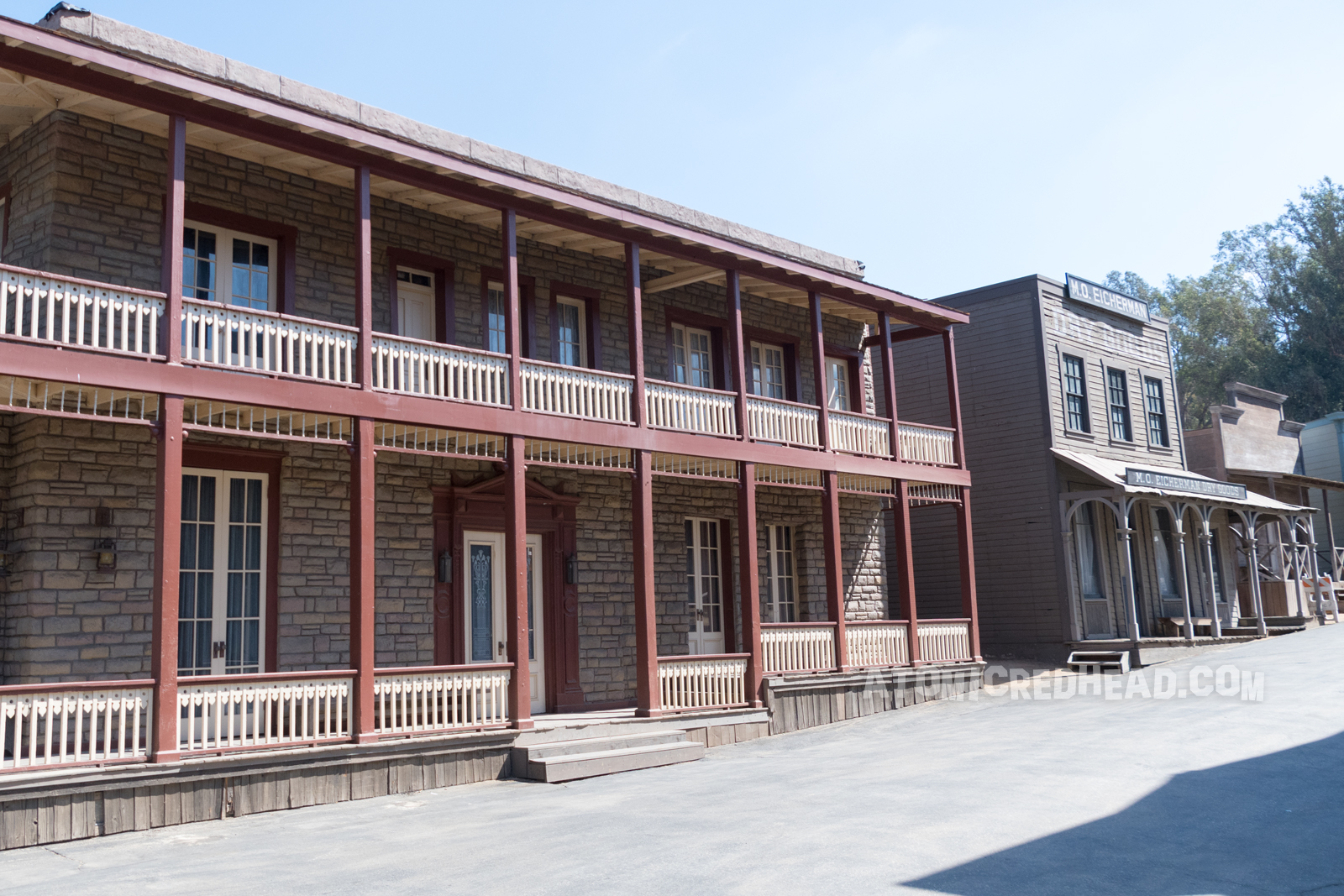 The stone building as it appears on the backlot, with the same maroon trim.