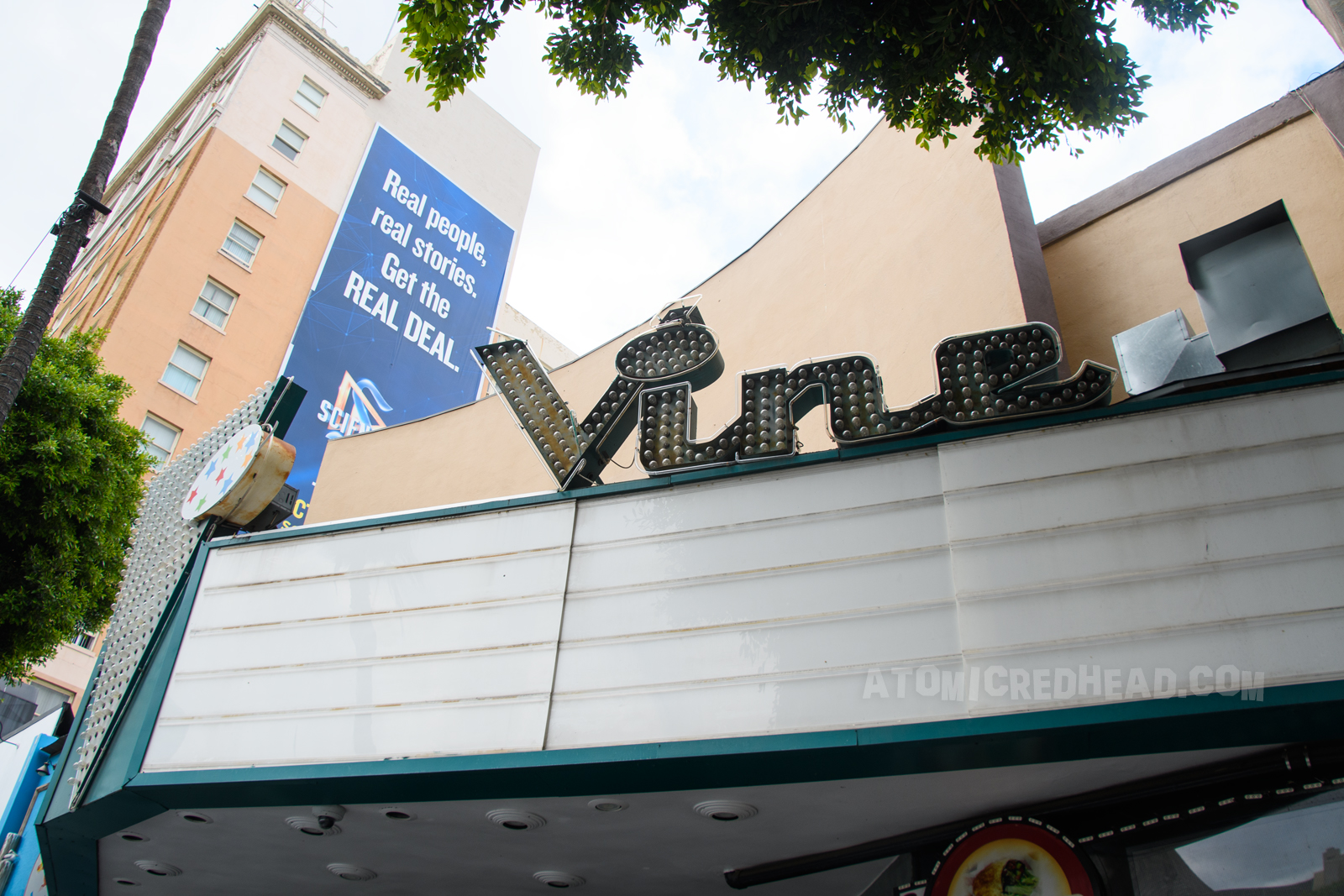 Marquee for the Vine theater. Script reads "Vine" with bulbs that would illuminate. A large V faces the street from the front of the marquee.