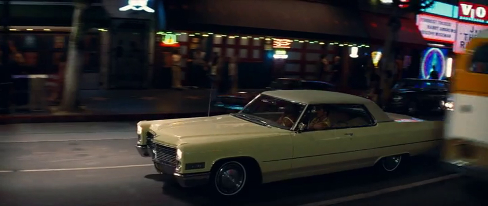 Rick and Cliff drive down Hollywood Boulevard the "V" from the Vogue is just barely visible in the upper right.