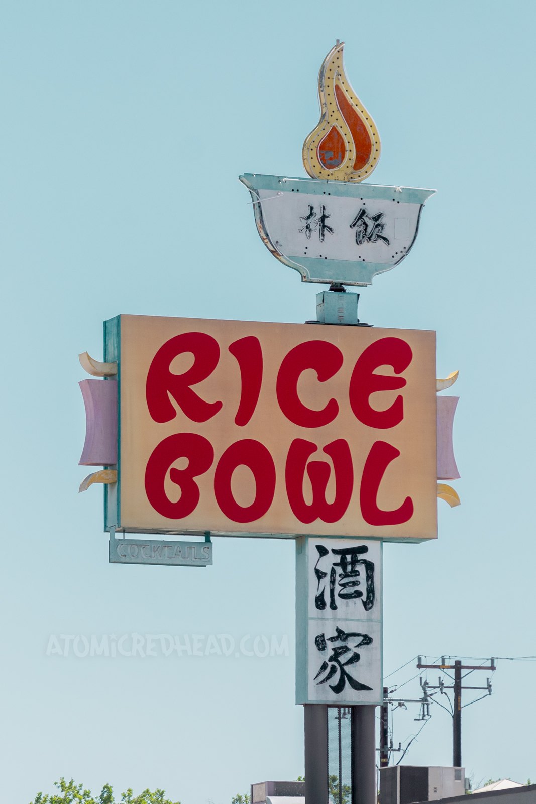 Extravagant neon sign for the Rice Bowl. A bowl with Chinese characters has a flame rising out of it. 