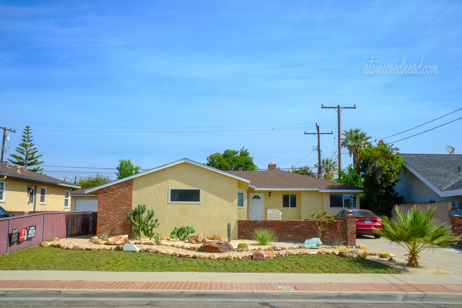 Our completed yard, a patch of green goes from the sidewalk to a rock edge pathway, past it features warm, decomposed granite and a variety of cacti. 