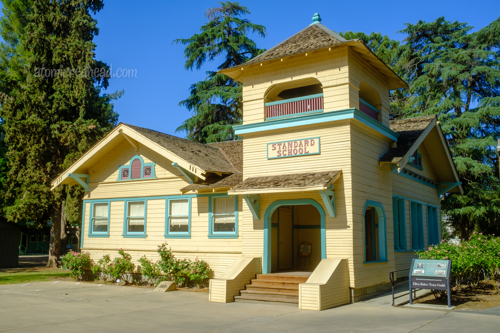 The Standard School, named for the Standard Oil Company, painted yellow with blue trim.