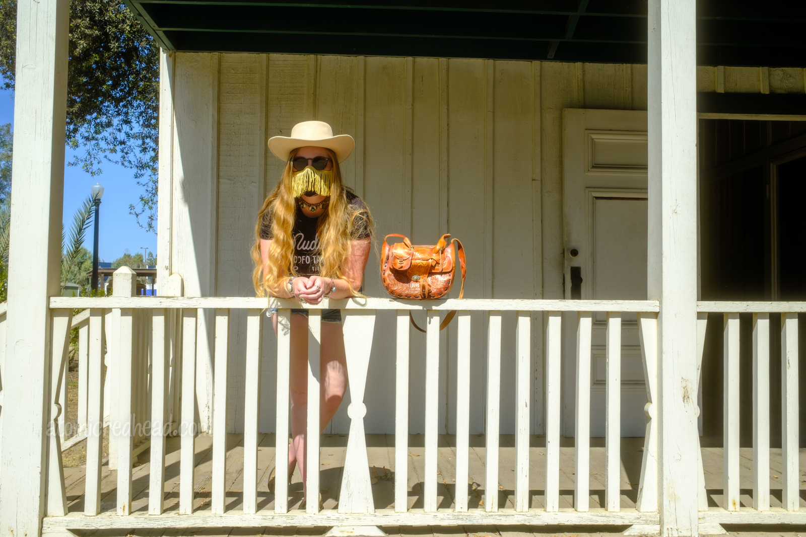 Myself leaning over a porch railing.