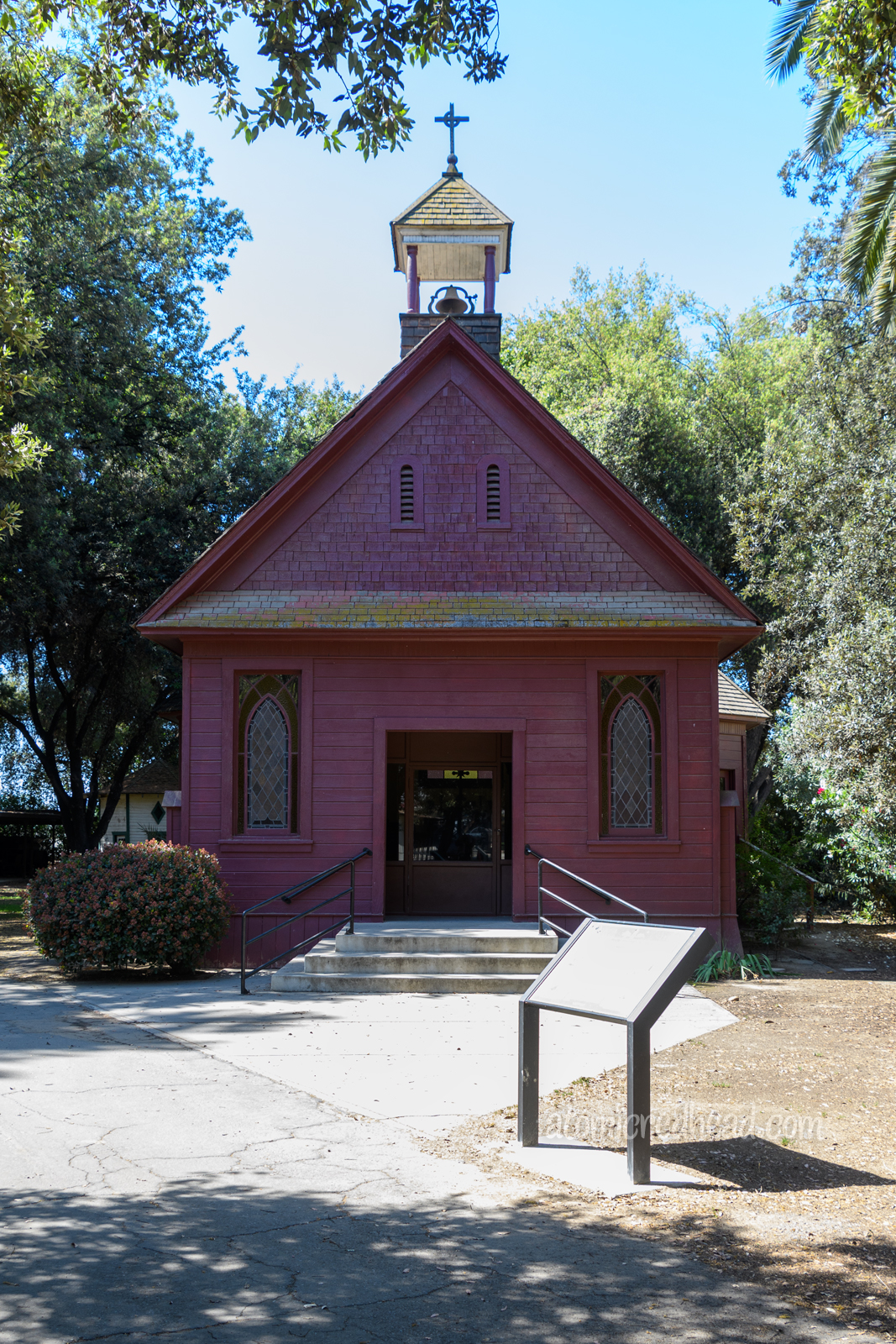 A little red church, with a steeple.