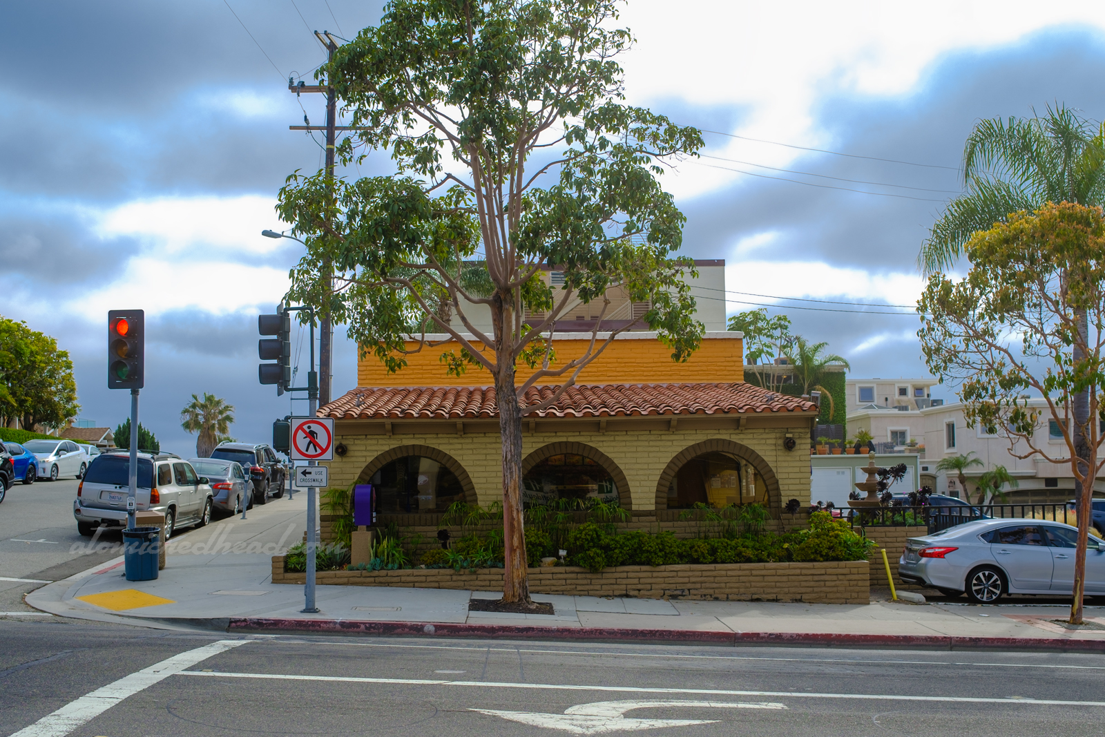 View of the Taco Bell, which is a brick structure painted in tan, brown, and orange.