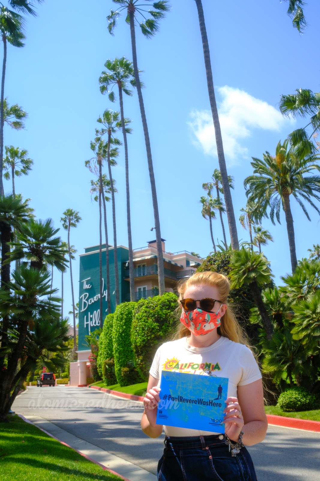 Myself standing in front of the Beverly Hills Hotel holding a sign that reads "#PaulRevereWasHere"