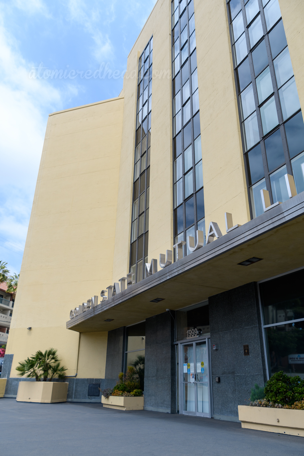 A simple cream building stands tall, a silver overhang features letters that spell out "Golden State Mutual Life"