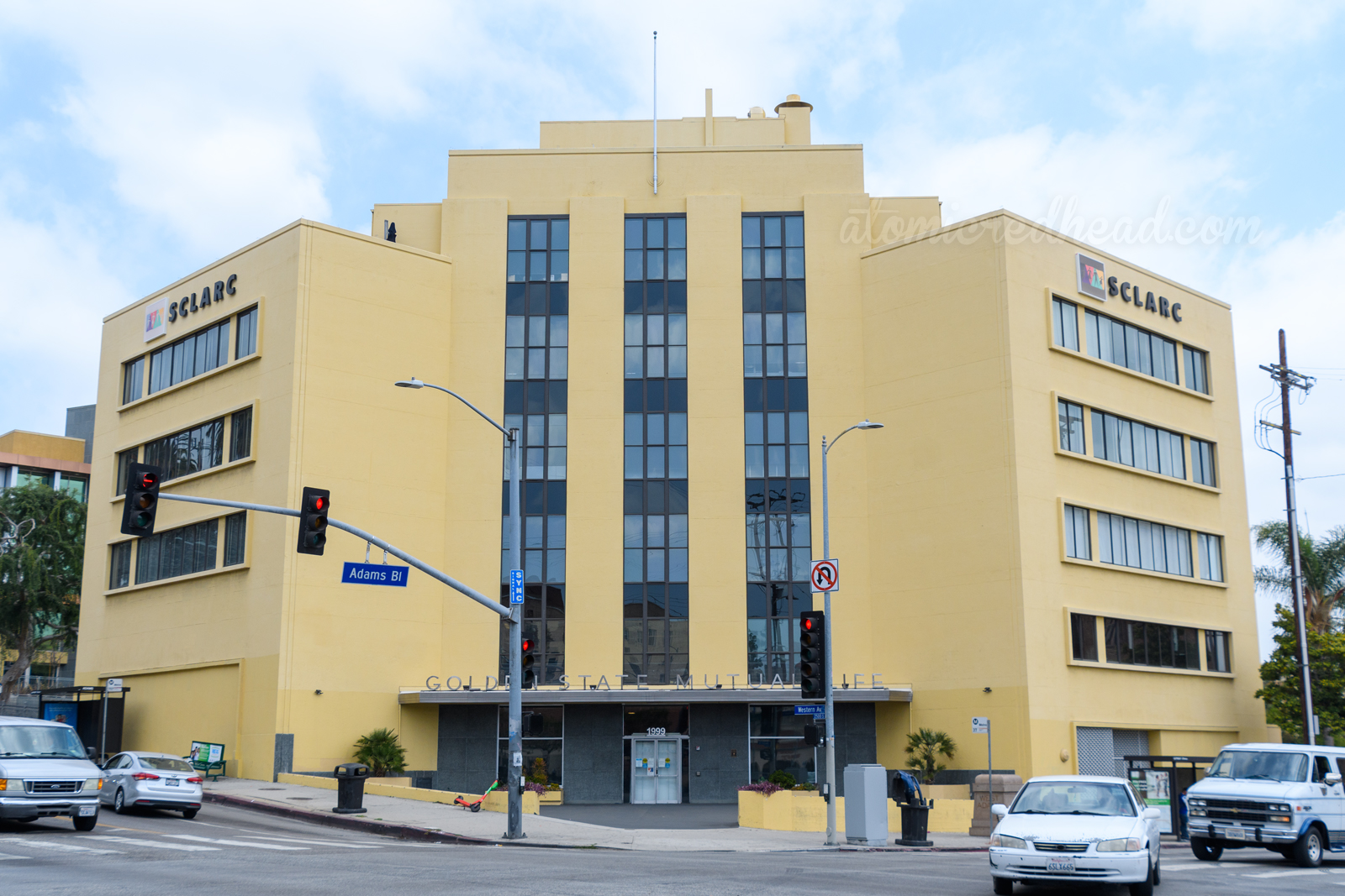 A simple cream building stands tall, a silver overhang features letters that spell out "Golden State Mutual Life"