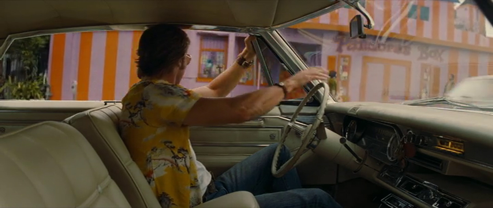 Cliff drives way from Pandora's box, in its garish paint job of orange and lavender. Funky script reading "Pandora's Box" is painted on the side.