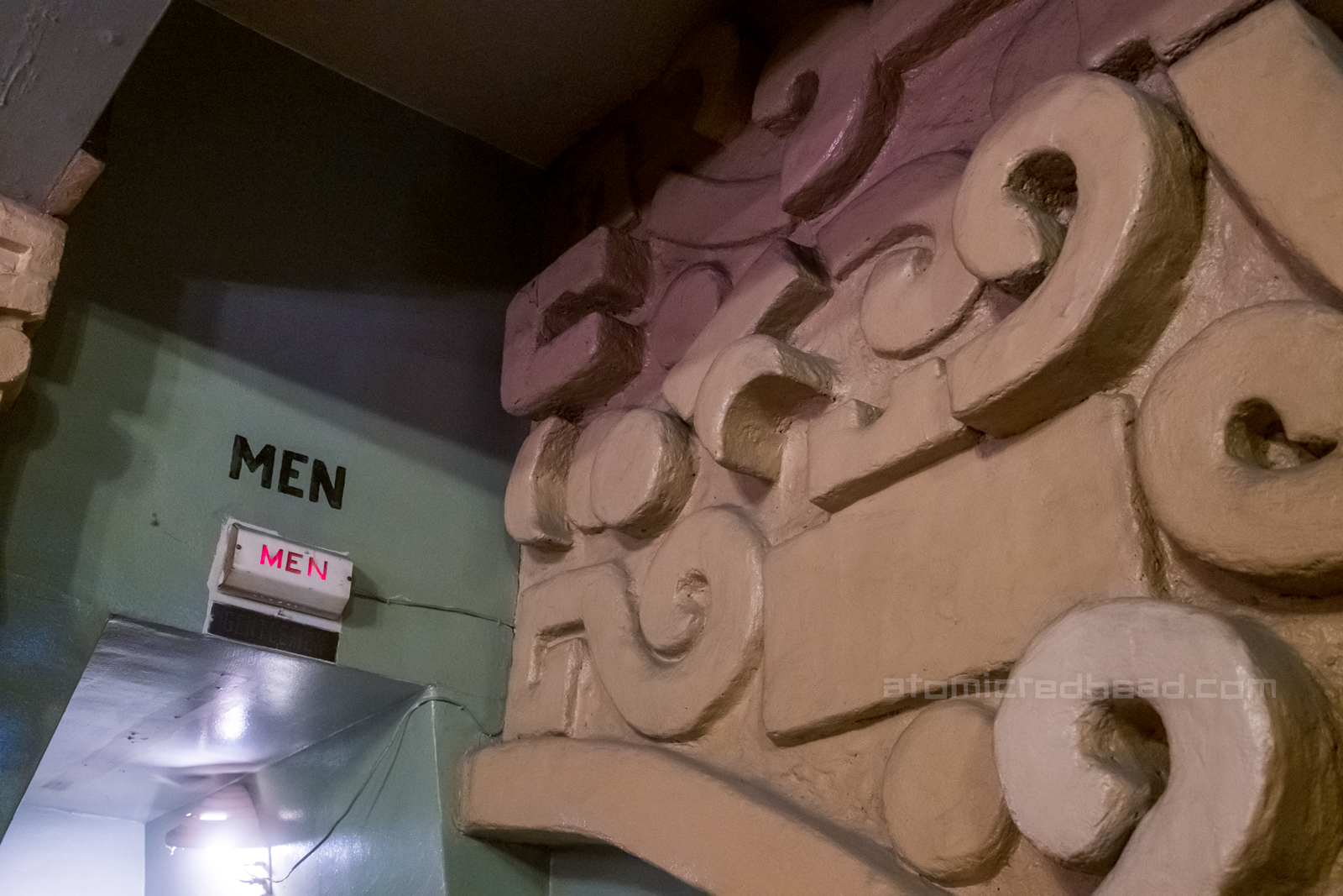 Mayan inspired swirls, curves and squares jut out from the wall.